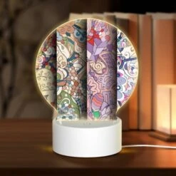 Round Acrylic Night Light, Three Colorful Paintings Are Displayed Side By Side.