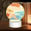 Round Acrylic Night Light, A Woman Wearing A Hat Sits On The Beach. 1 Round Acrylic Night Light, A Woman Wearing A Hat Sits On The Beach. -Cute Night Light Shop 559bcb805aa374d3fbf2721e66d5012a00490813