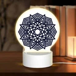 Round Acrylic Night Light, A Black And White Geometric Design.