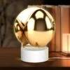 Round Acrylic Night Light, A Group Of Gold Eggs Are Sitting On A White Background. -Cute Night Light Shop 79b0f21ebd7496b3310259a038cc761bb68d4de5