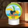Round Acrylic Night Light, A Woman Wearing A Grass Skirt And A Sun Hat Is Standing On A Beach.