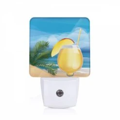 Night Light, A Glass Of Yellow Liquid Is Sitting On A Sandy Beach