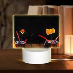 Rectangular Acrylic Night Light, A Table With Two Cups Of Candy And A Lit Candle.