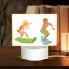 Rectangular Acrylic Night Light, A Cartoon Of A Man And A Woman Surfing. -Cute Night Light Shop 9f50abda74e08f2733e196973a530593da71b15e