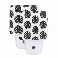 Night Light Set Of 2, A Pattern Of Leaves On A Black And White Background.
