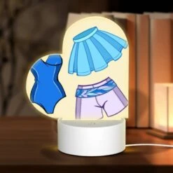 Front Page 37 Love Acrylic Night Light, A Blue And Purple Bathing Suit With A Blue Skirt And A Blue Top.