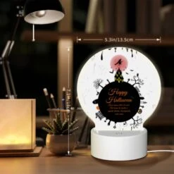 Round Acrylic Night Light, A Black And White Poster With A Witch On A Broomstick And The Words "Happy Halloween" Written In Orange. -Cute Night Light Shop b9dadc7c294de9ed0477c28ae9ec3923ca14df10