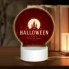 Round Acrylic Night Light, A Halloween Poster With A Castle And A Trick Or Treat Message.