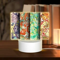 Rectangular Acrylic Night Light, Four Different Colored Designs Of Flowers Are Displayed On A Wall.