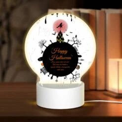 Round Acrylic Night Light, A Black And White Poster With A Witch On A Broomstick And The Words "Happy Halloween" Written In Orange.