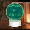 Round Acrylic Night Light, A Green And White Sign Welcoming Visitors To Palm Beach. -Cute Night Light Shop f2f7198d6d846b1f56487177ef74a42e214ac3e0