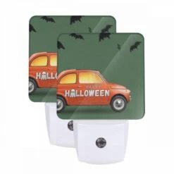Night Light Set Of 2, A Small Orange Car With A Bumper Sticker That Says "Happy Halloween!"